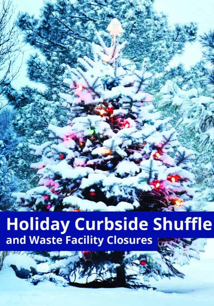 Festive snow-covered Christmas tree decorated with colorful lights in winter landscape.